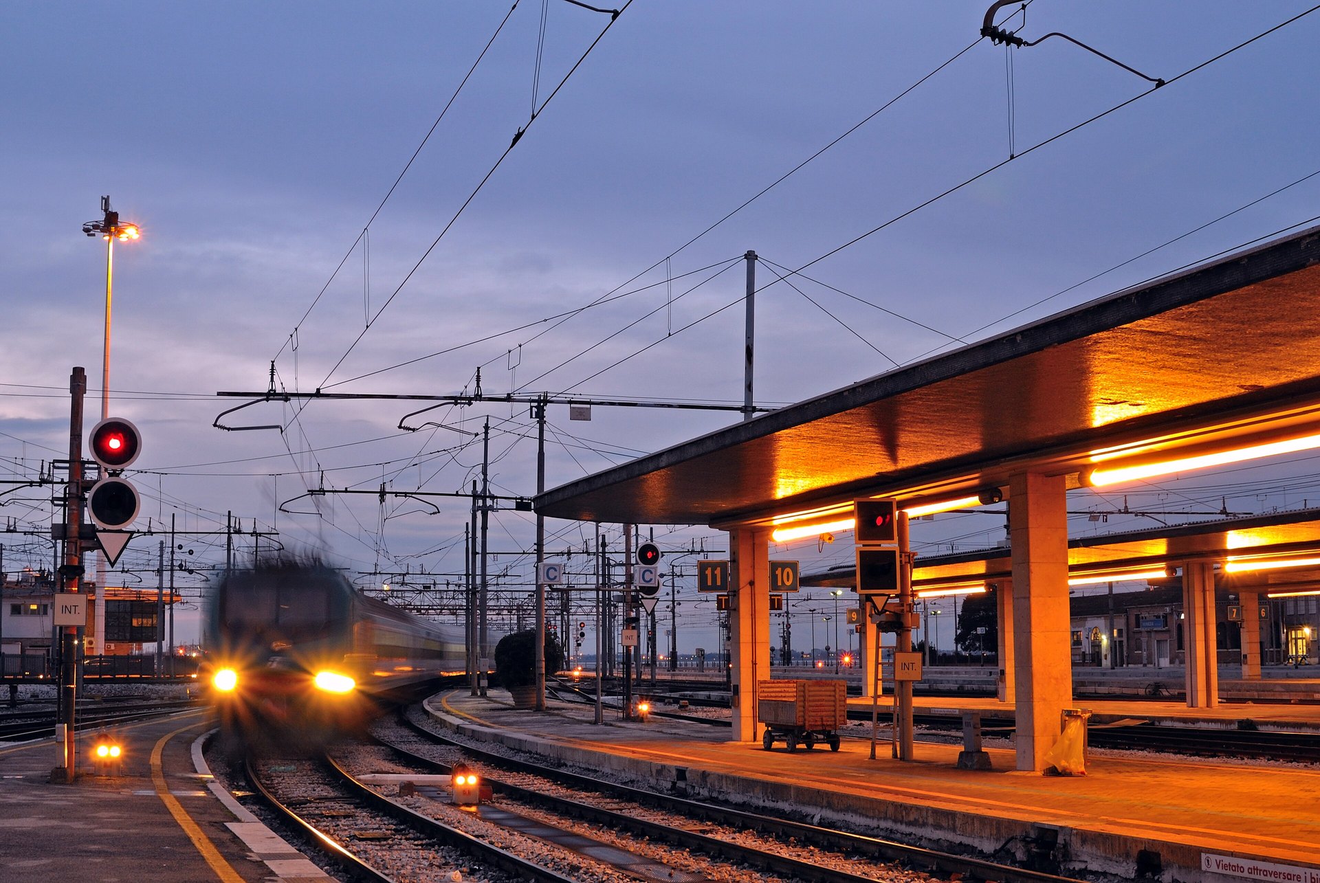Venezia Santa Lucia station at blue hour, with a train arriving at the platform